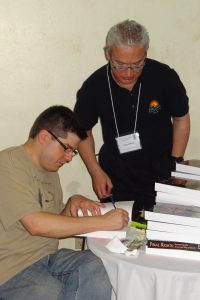Exec. Director Josh Slocum signs a copy of "Final Rights" for Gary Paul Gilbert, FCA of Long Island and New York.
